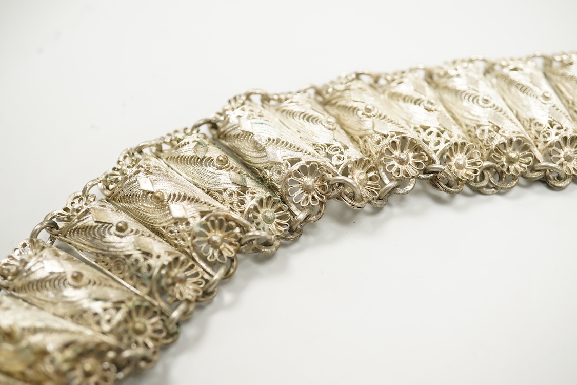 An Indian white metal filigree belt, 86cm.